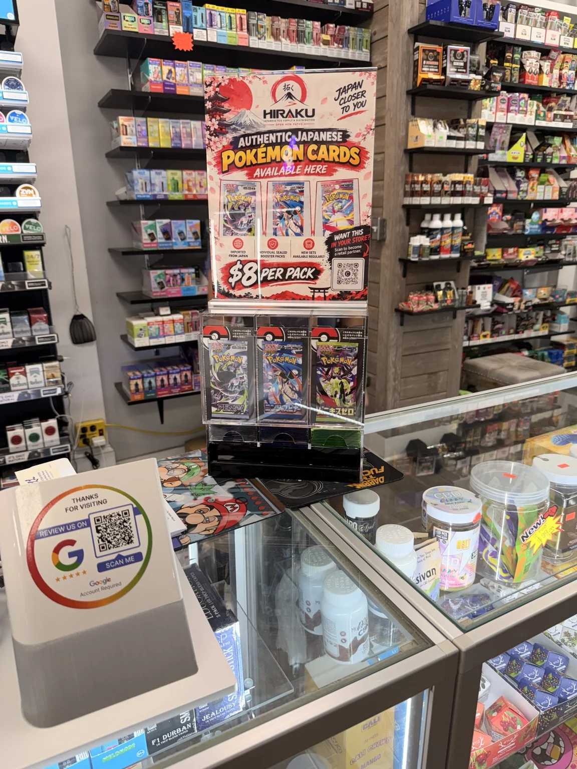 HIRAKU TCG display installed on a retail counter